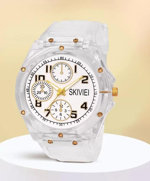 Clear wristwatch with gold accents on a light yellow background