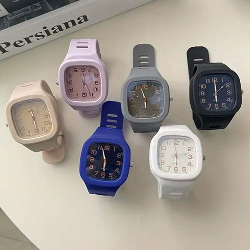 Collection of colorful square watches on a white surface with 'Persiana' branding.