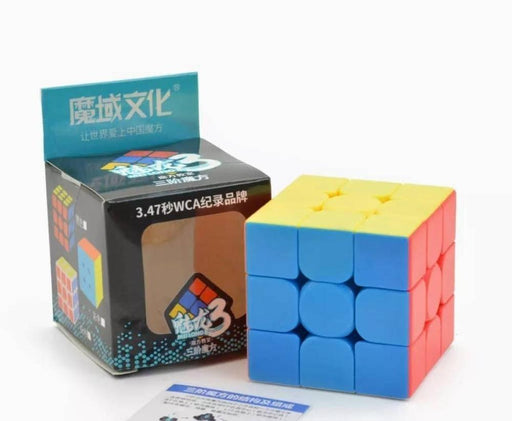 Rubik's Cube with packaging and manual on a white background