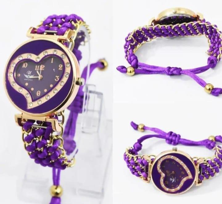 Purple heart-shaped watch with gold accents on a white background