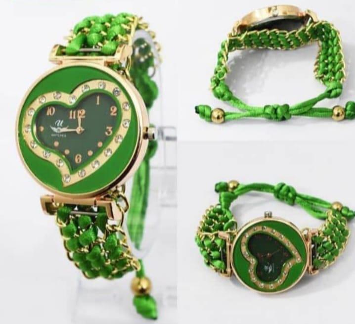 Green heart-shaped watch with green bracelet on a white background