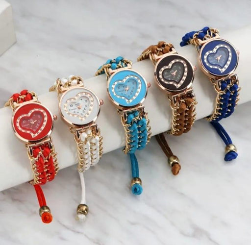 Five colorful wristwatches with heart designs on a marble surface