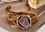 Bracelet with a decorative watch face on a reflective surface