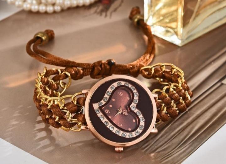 Bracelet with a decorative watch face on a reflective surface
