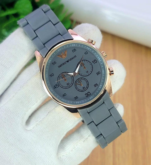 Gray watch with a gold case on a white background