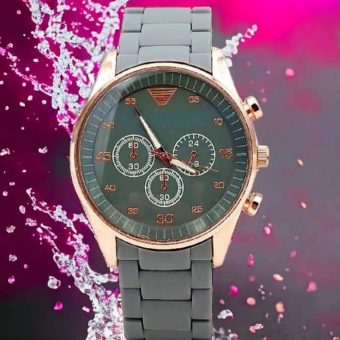 Wristwatch with a green face and rose gold accents on a colorful background