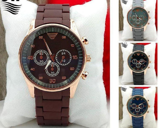 Watch with brown strap and black dial on a white cushion, surrounded by other watch images.