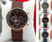 Watch with brown strap and black dial on a white cushion, surrounded by other watch images.