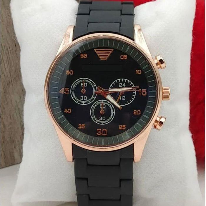 Wristwatch with black strap and rose gold case on a white cushion