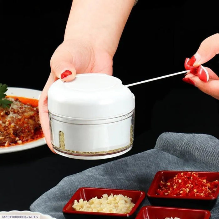 Person using a small white container with a spoon, surrounded by food on a dark surface.