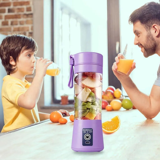 Two people drinking orange juice from a purple portable blender filled with fruits in a kitchen setting.