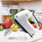 White electric hand mixer with attachments on a kitchen counter with vegetables in the background