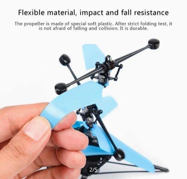 Hand holding a small blue and black propeller with text about its durability.