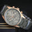Wristwatch with gray band and rose gold case on a dark background