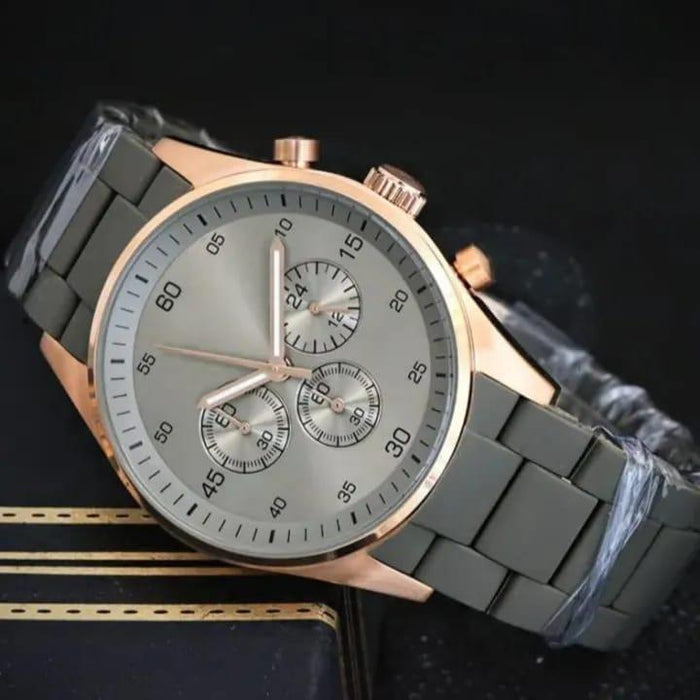 Wristwatch with gray band and rose gold case on a dark background