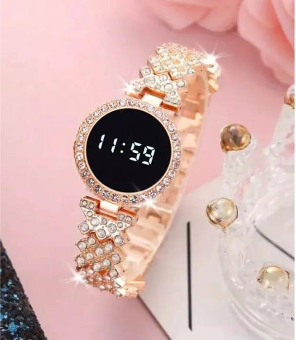 Rose gold digital watch with gemstone accents on a pink background