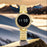 Gold digital watch with diamond-like accents on a rock with a mountainous background