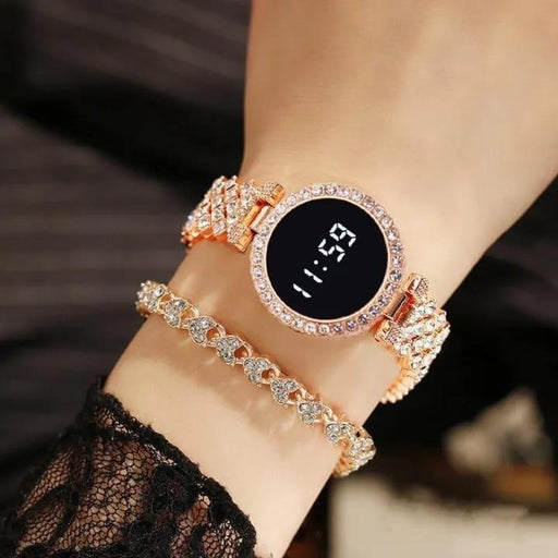 Rose gold digital watch with diamond accents on a wrist against a blurred background