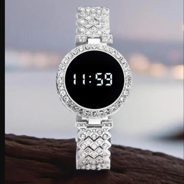 Digital watch with diamond-studded band on a blurred background