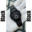 Black watch on a white surface with 'Black' text on either side.