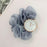Gray scrunchie with a gold watch on a light pink background