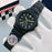 Black watch with gold accents on a white glove