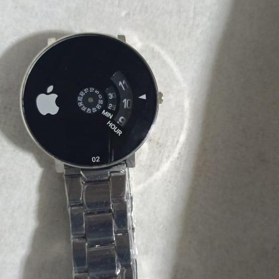 Smartwatch with a metallic band on a white surface
