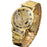 Gold wristwatch with a detailed mechanical design on a white background