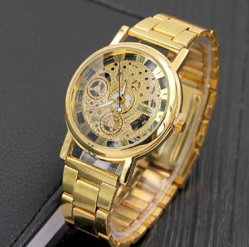 Gold wristwatch with intricate design on a dark background