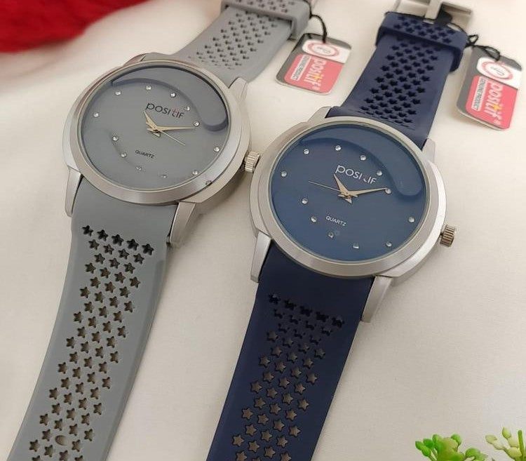 Two watches with star-patterned straps on a white background