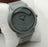 Gray wristwatch with 'positif' brand on a white background