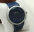 Blue watch with silver case on a white background