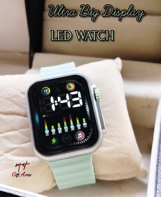 Smartwatch with a light green band on a cushion, text 'Ultra Big Display LED WATCH' above.