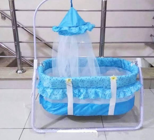 Blue baby crib with canopy in a home setting