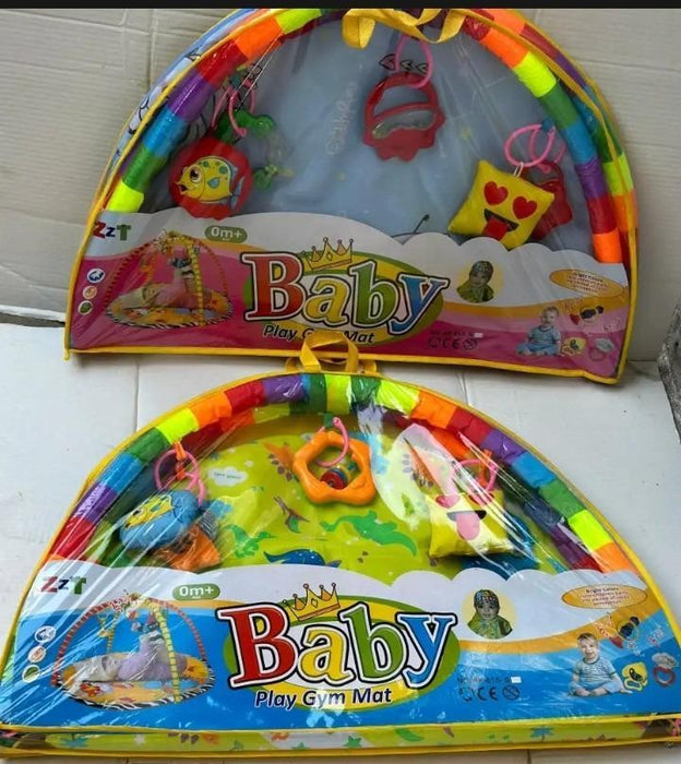 Colorful baby play gym mat with various hanging toys on a white background