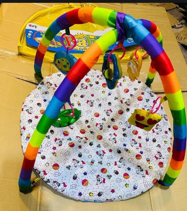 Colorful baby play gym with toys on a patterned mat