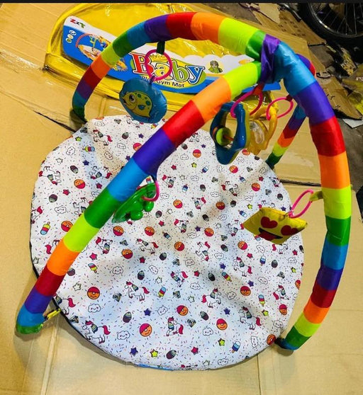 Colorful baby gym with toys on a patterned mat
