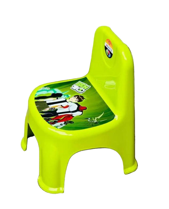 Green children's stool with cartoon design on a concrete floor.