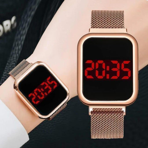 Two digital wristwatches with rose gold mesh bands and red LED display on a person's wrist.